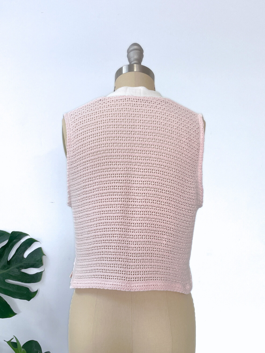 Pink knitted vest on a mannequin with a white background