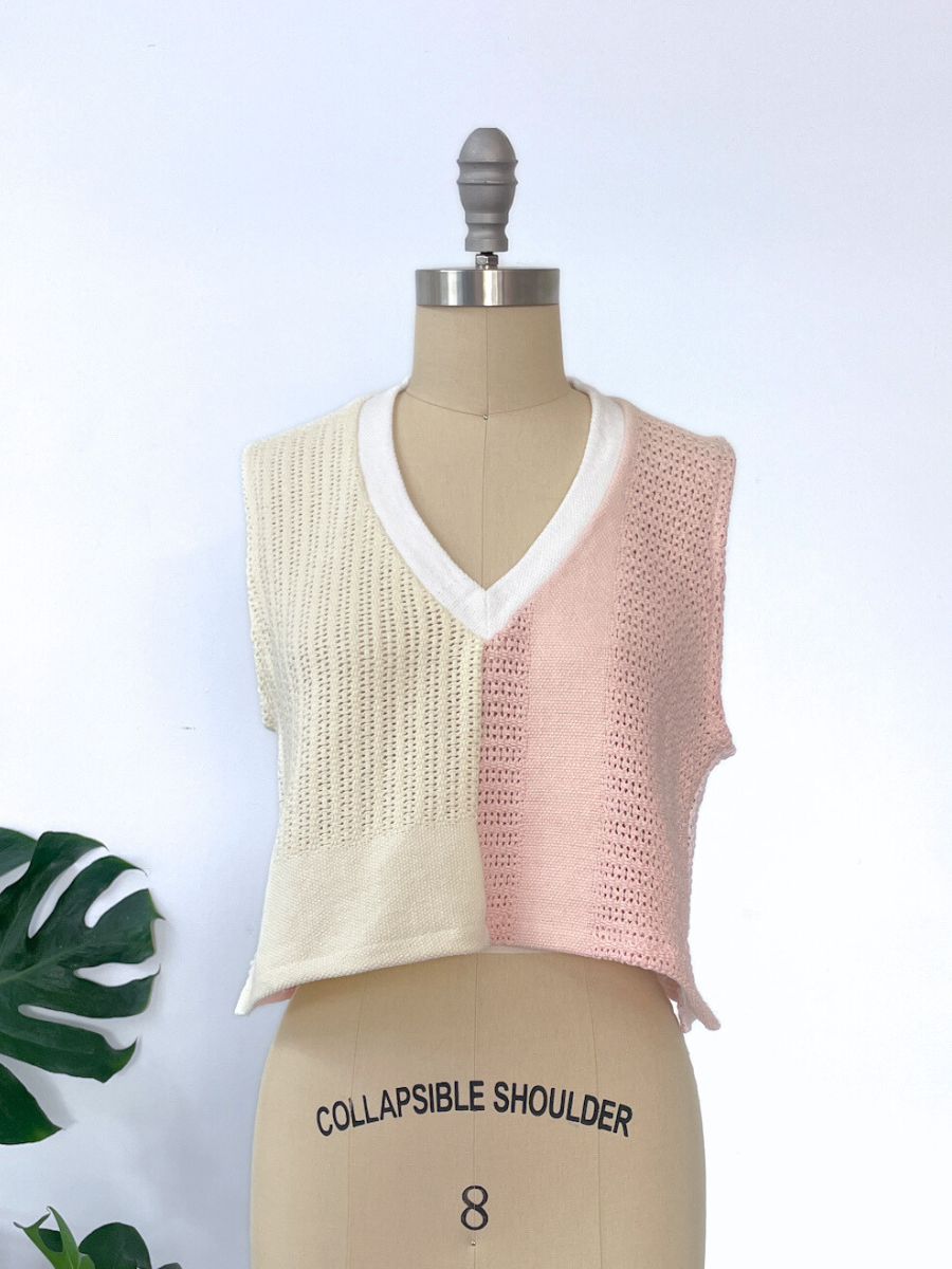 Two-tone knit v neck vest in yellow and pink on a mannequin with a white background